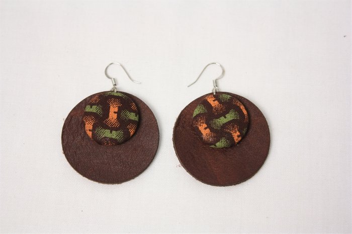 Circular two-tone brown leather earrings with a patterned centre disc