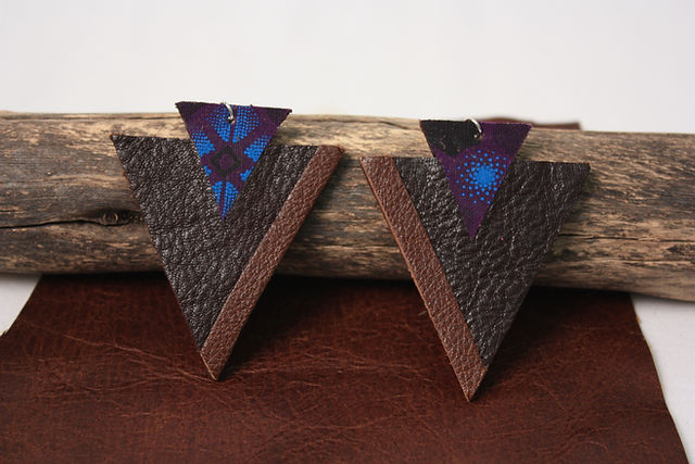Dark leather triangle drop earrings with a purple and blue patterned accent