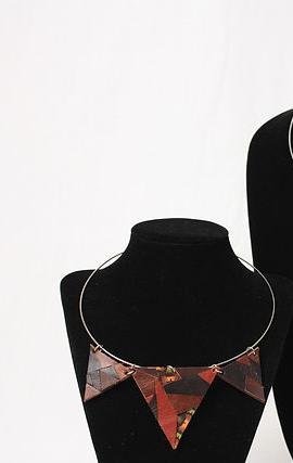 A triangular bib-style leather necklace in red and burgundy tones
